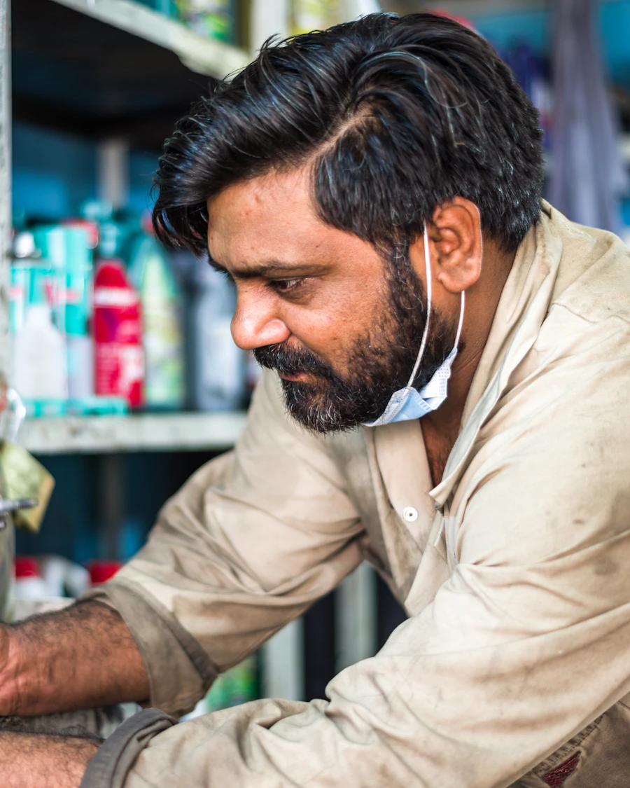 A technician working over a parts bench.